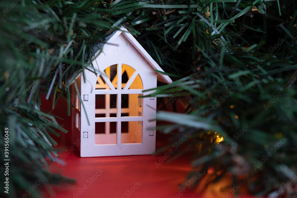 glowing wooden houses garland on the tree. New year and christmas concept, real estate concept