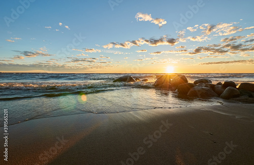 sunset by the bay, stones and waves