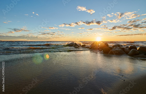 sunset by the bay, stones and waves