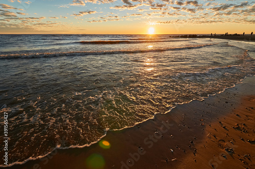 sunset on the sandy beach of the gulf of finland