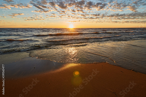 sunset on the sandy beach of the gulf of finland