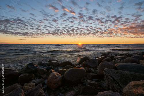 sunset by the bay, stones and waves