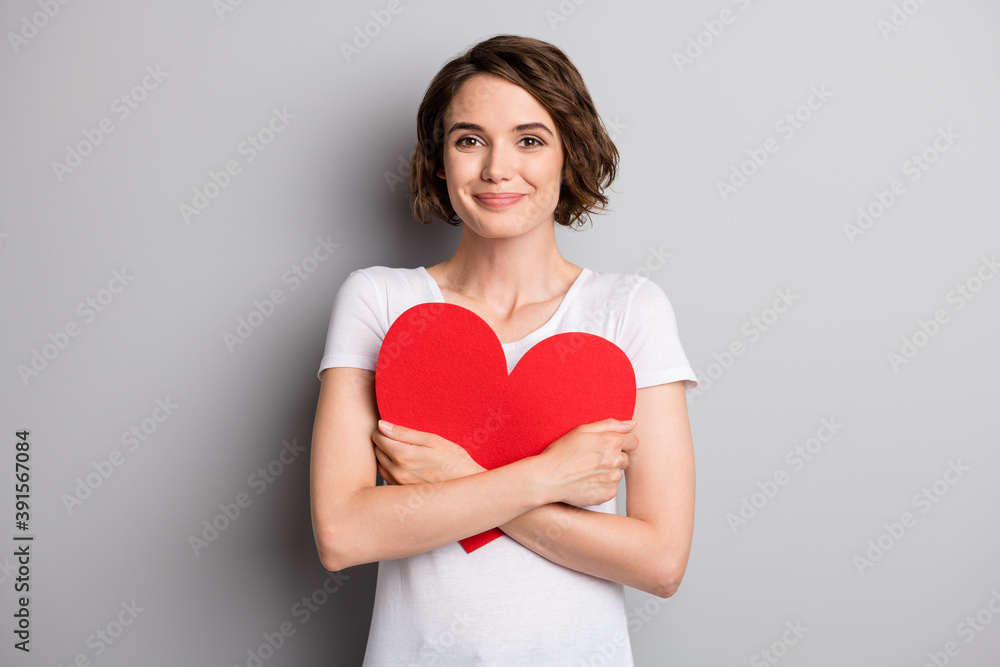 Photo of young attractive girl happy positive smile hug embrace big paper card present gift isolated over grey color background Photo of young attractive girl happy positive smile hug embrace big paper card present gift isolated over grey color background