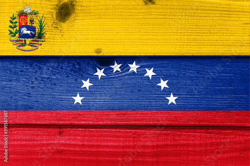 Venezuela flag painted on old wood plank background. Brushed natural light knotted wooden board texture. Wooden texture background flag of Venezuela.