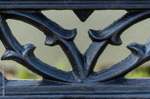 Fragment of cast-iron fence in the park - artistic metal casting. 1