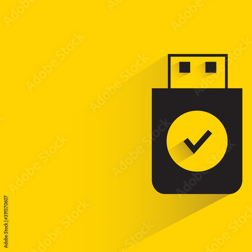 secured thumb drive with shadow on yellow background