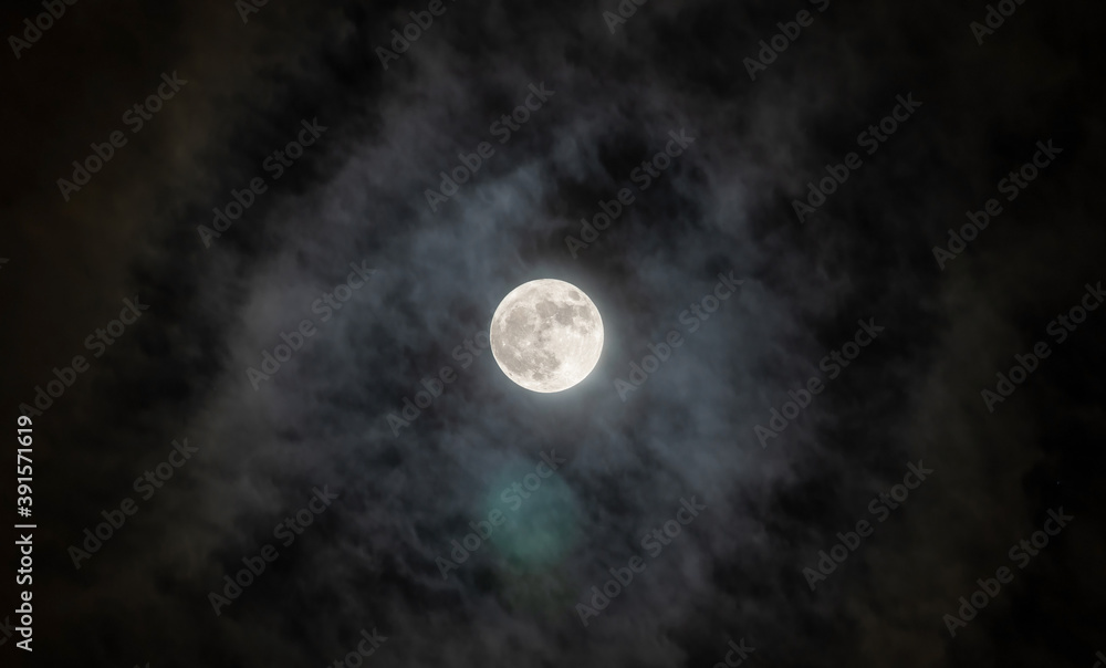 Full moon with fog and cloudy. The moon was not furnished. The night sky and a full moon in the clouds.