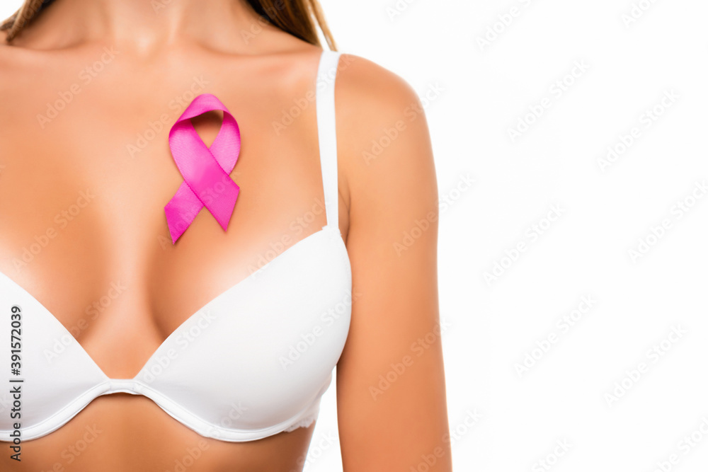 Cropped view of pink sign of breast cancer awareness on chest of woman in bra isolated on white