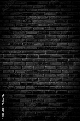 Black brick walls that are not plastered background and texture. The texture of the brick is black. Background of empty brick basement wall. photo