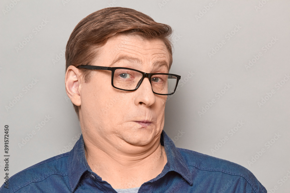 Portrait of funny confused surprised man with glasses Portrait of funny confused surprised man with glasses