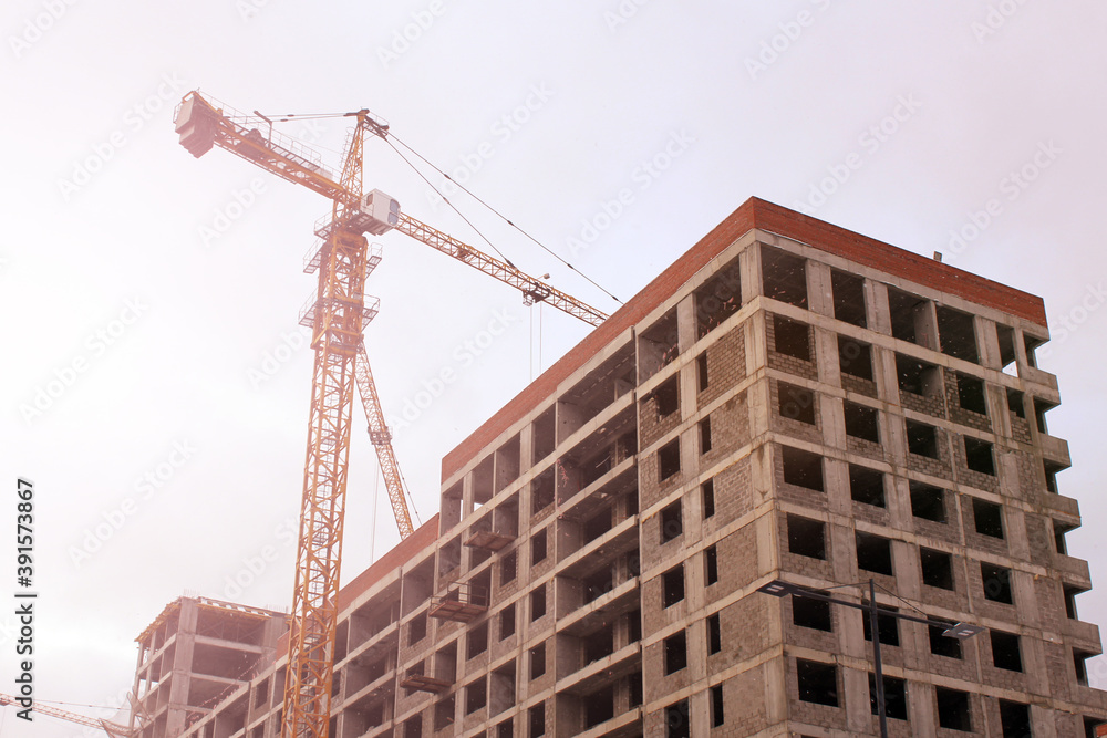 Crane and workers at construction site