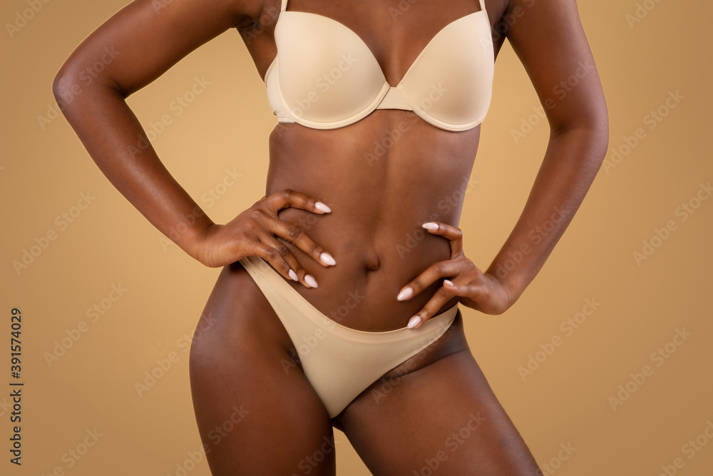 Closeup shot of beautiful slim black female body in underwear - obrazy, fototapety, plakaty 