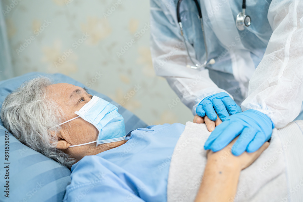 Doctor using stethoscope to checking Asian senior or elderly old lady woman patient wearing a face mask in hospital for protect infection Covid-19 Coronavirus. Doctor using stethoscope to checking Asian senior or elderly old lady woman patient wearing a face mask in hospital for protect infection Covid-19 Coronavirus.