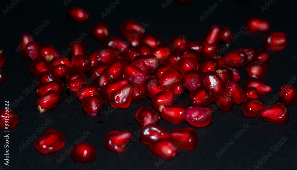 pomegranate seeds on black background pomegranate seeds on black background
