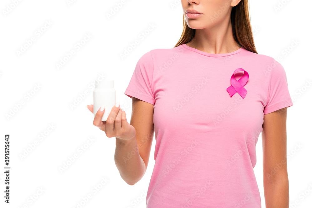 Cropped view of woman with ribbon of breast cancer awareness holding jar with pills isolated on white