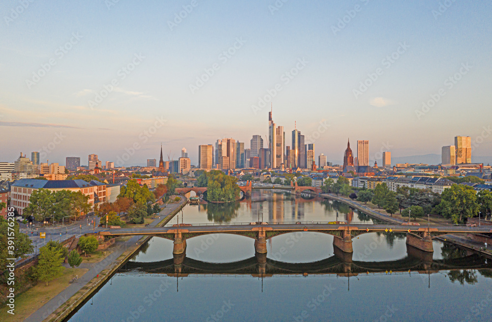 Aerial picture of the Frankfurt skyline and river main during sunrise with reflections in water and glass facades of the skyscrapers