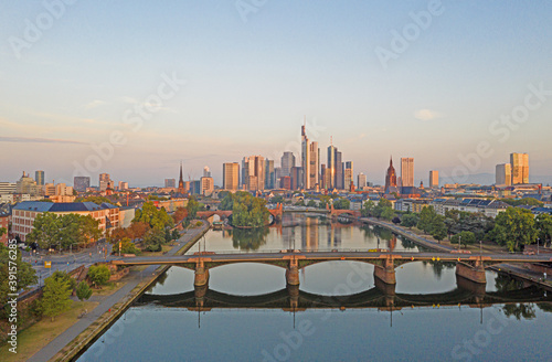 Aerial picture of the Frankfurt skyline and river main during sunrise with reflections in water and glass facades of the skyscrapers