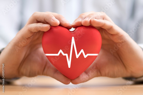 Heart pulse in hands. Health insurance concept