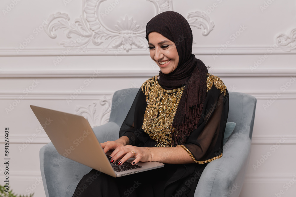 arab business woman working on laptop from home arab business woman working on laptop from home