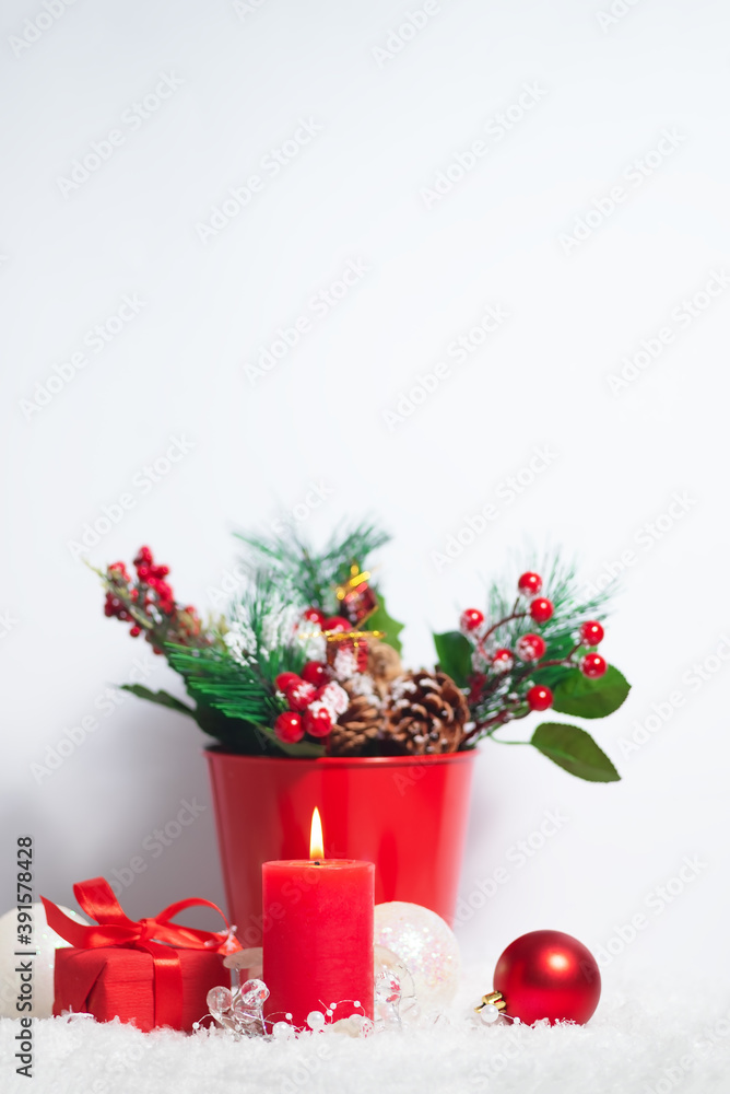 Vertical christmas card composition with snow and Christmas tree branches decoration and present boxes on the white