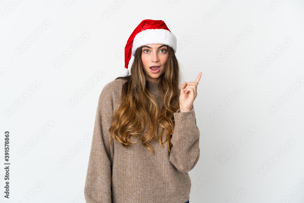 Caucasian girl with christmas hat isolated on white background intending to realizes the solution while lifting a finger up Caucasian girl with christmas hat isolated on white background intending to realizes the solution while lifting a finger up