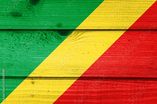 the Republic of the Congo flag painted on old wood plank background. Brushed natural light knotted wooden board texture. Wooden texture background flag of the Republic of the Congo