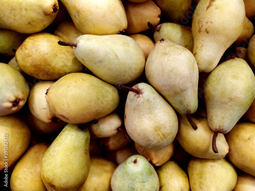 Pears. Lots of yellow pears in the supermarket. Storage of pears. Selling pears. View from above. Healthy snacks. Texture. Background. Fruit.