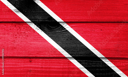 Trinidad and Tobago flag painted on old wood plank background. Brushed natural light knotted wooden board texture. Wooden texture background flag of Trinidad and Tobago. © DAWT_PHOTO