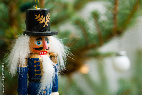 blue nutcracker ornament hanging on Christmas tree
