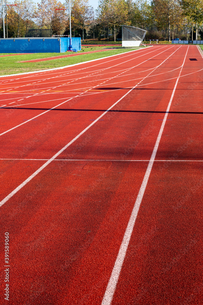 Fototapeta premium Red running lane on outdoor school stadium