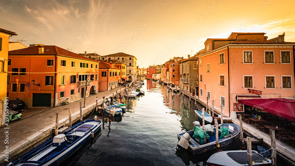 Romantic cityscape of Ghioggia - near Venice - with canals, buidings, bridges and canals in sunset sunlight. Bridge di Vico