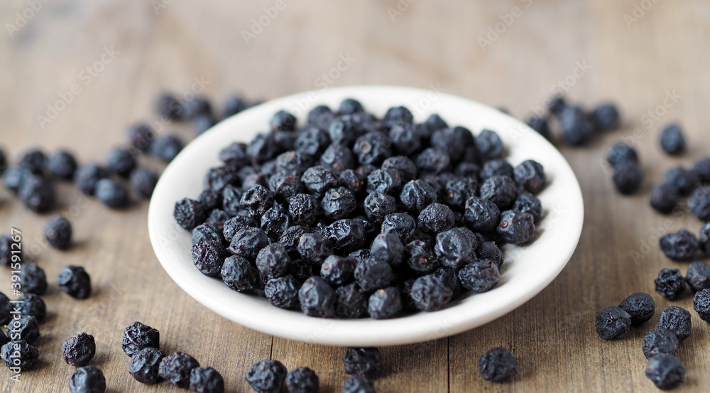 Home preparation of dried fruits.Wooden background with dried bird cherry. Home preparation of dried fruits.Wooden background with dried bird cherry.