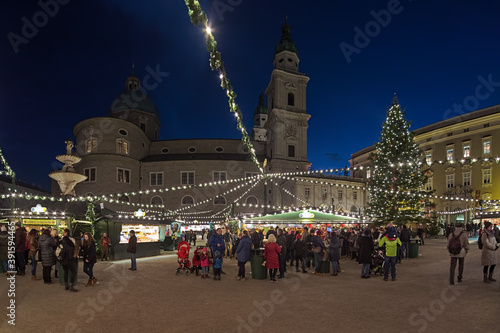 Salzburg, Austria. Christmas market at the Residenzplatz square close to the Salzburg Cathedral in twilight. photo