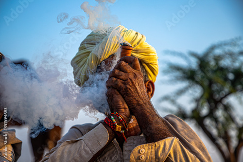 Canvas Print a rajasthani tribal man smoking chillam at pushkar