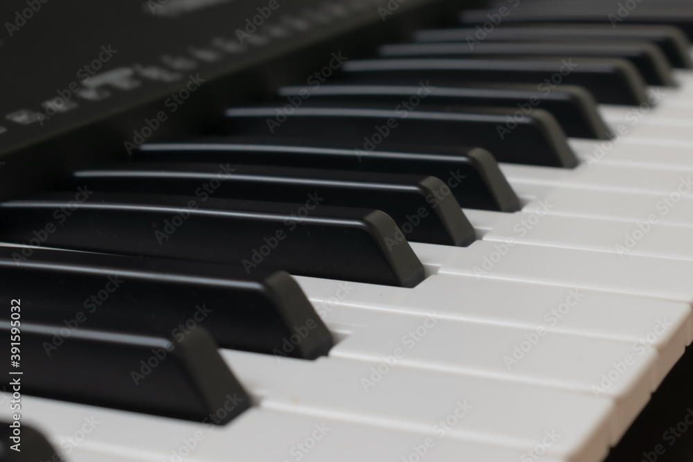 Piano keyboard. Musical background. Piano with a red gift. Piano keyboard. Musical background. Piano with a red gift.