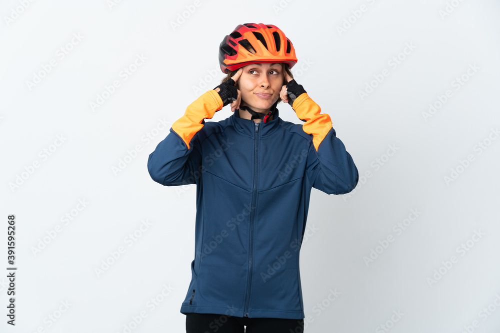 Fototapeta premium Young English cyclist woman isolated on white background having doubts and thinking