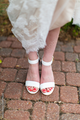 Woman in white formal shoes.