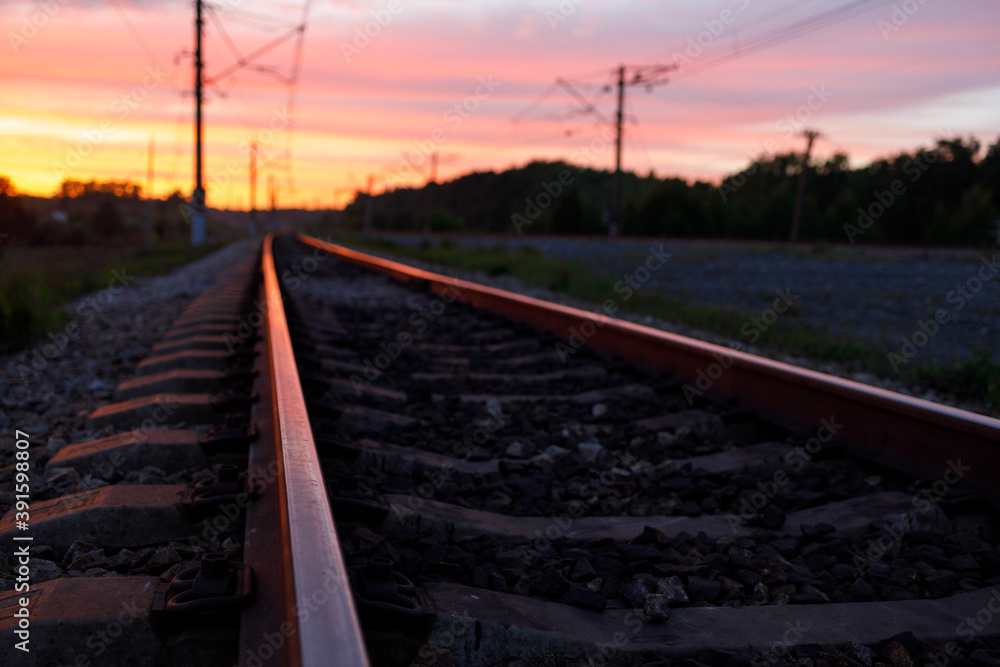 Fototapeta premium railway rails during sunset with reflections on the metal