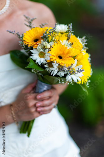 Woman holding bouquet of flowers.