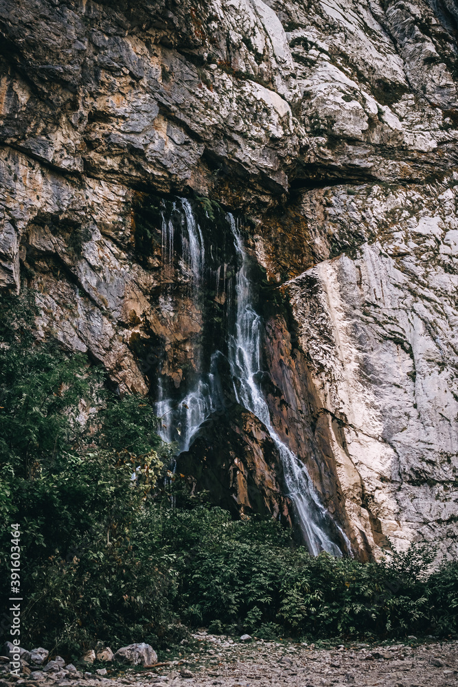 Beautiful view of waterfall in the mountains.