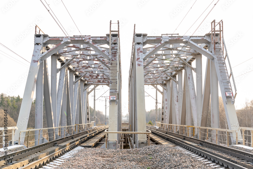 Naklejka premium metal railway bridge over a small river, selective focus, tinted image