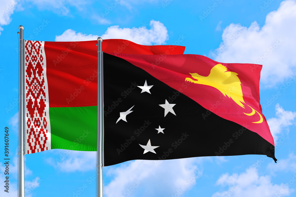 Papua New Guinea and Belarus national flag waving in the windy deep blue sky. Diplomacy and international relations concept. Papua New Guinea and Belarus national flag waving in the windy deep blue sky. Diplomacy and international relations concept.
