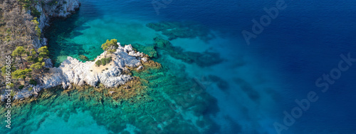 Aerial drone ultra wide panoramic view of tropical paradise sandy beach visited by sailboats and yachts in Caribbean exotic destination island