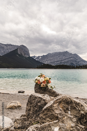 Close up of bridal bouquet with mountains in the background. Rocky Mountains, Alberta, Canada.