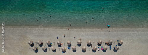Aerial drone ultra wide panoramic photo of organised with umbrellas and sunbeds turquoise sandy beach in Mediterranean destination island