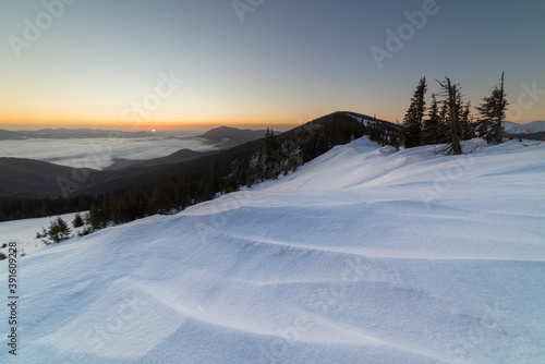 Winter in the Ukrainian Carpathian mountains with morning fogs