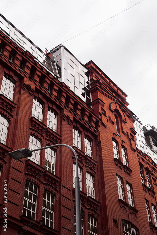 European old-new red brick building in Moscow. windows with white frames. loft-style city building office center