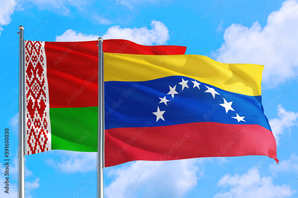 Venezuela and Belarus national flag waving in the windy deep blue sky. Diplomacy and international relations concept. Venezuela and Belarus national flag waving in the windy deep blue sky. Diplomacy and international relations concept.