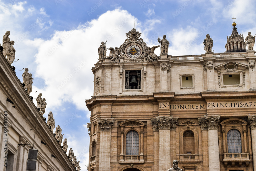 Architectural details of Saint Peter's Basilica and some of the statues on the doric columns that surround Saint Peter's Square. Vatican, Rome, Italy.