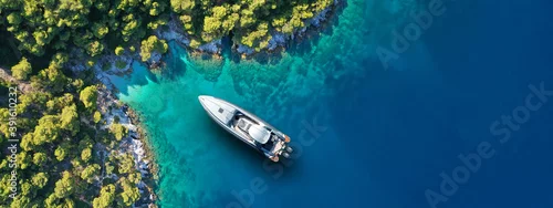 Obraz  z motywem Aerial drone ultra wide panoramic photo of luxury yacht anchored in tropical exotic island with crystal clear turquoise sea and pine trees
